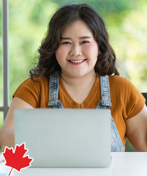 Young overweight Asian woman at her desk at work.
